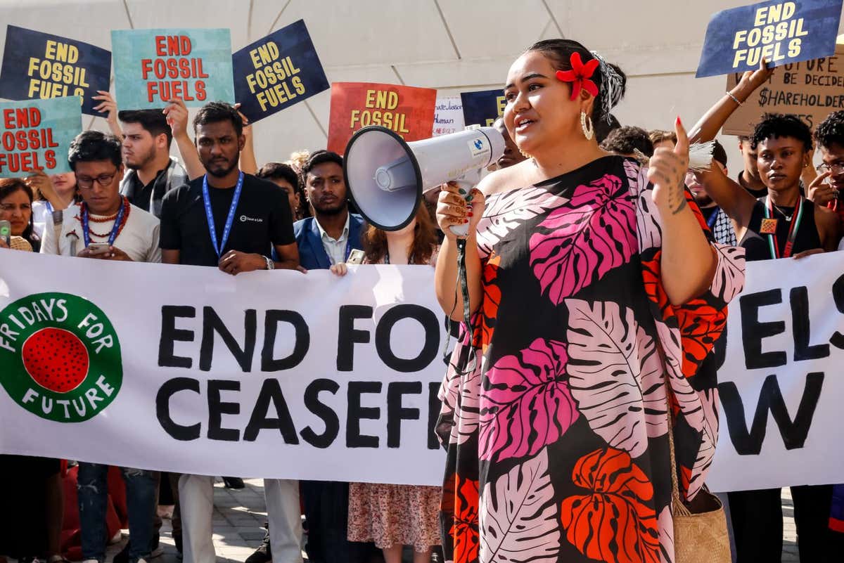 Youth from Fridays for Future organization stage a protest calling to cease fires and end fossil fuels in the conference venue, Blue Zone during the COP28, UN Climate Change Conference, held by UNFCCC in Dubai Exhibition Center, United Arab Emirates on December 8, 2023. COP28, running from November 30 to December 12 focuses on particular nations' decarbonisation goals. The Conference in Dubai focuses also on the most vulnerable communities and Loss and Damage (Photo by Dominika Zarzycka/NurPhoto via Getty Images)