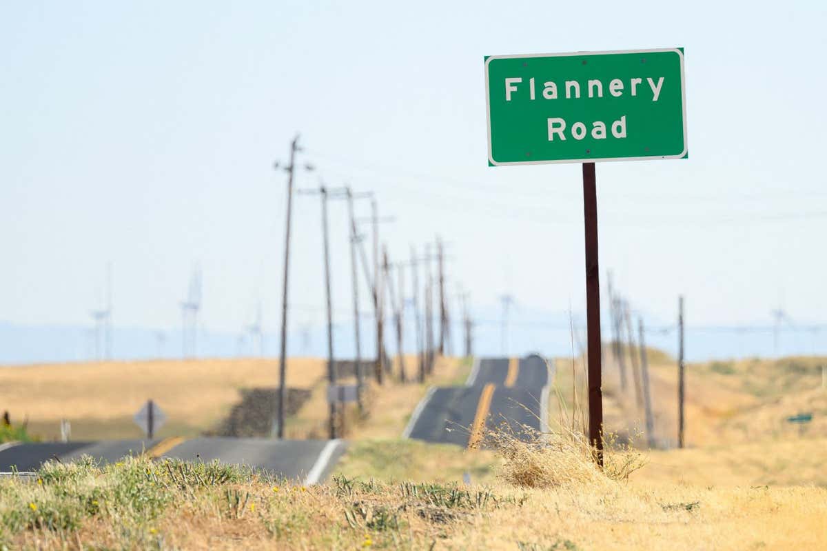 A road sign is posted near a parcel of land recently purchased by Flannery Associates near Rio Vista, California on September 15, 2023. A stealth campaign by Silicon Valley elites with a dream of turning a swath of California farmland into a new age city has ranchers who live here challenging their tactics as well as their motives. The project first surfaced when a mysterious buyer started gobbling up parcels of land in this rural outback between San Francisco and Sacramento. The buyer, first revealed by the New York Times in August, turned out to be a secretive outfit called Flannery Associates. (Photo by JOSH EDELSON / AFP) (Photo by JOSH EDELSON/AFP via Getty Images)